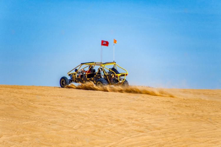 stock-photo-raising-a-cloud-of-sand-and-dust-off-road-dune-buggy-riding-a-sand-dune-in-the-imperial-sand-dunes-1284895972_3_-_Copy-transformed_1